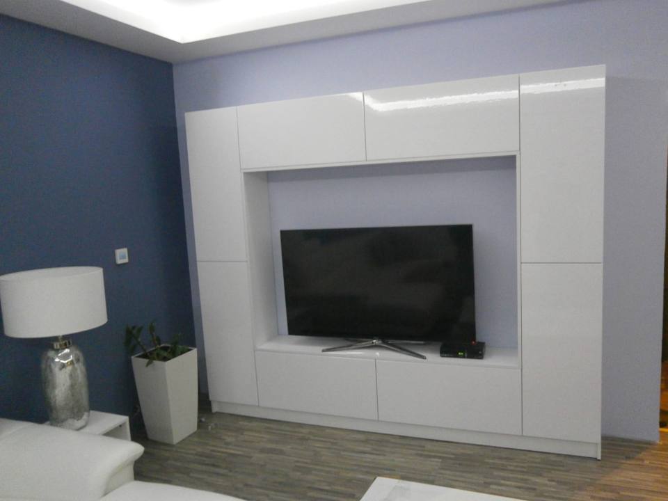 Weiße Fächerwand um den Fernseher an der blauen Wand