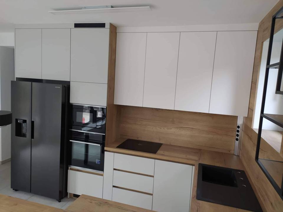 Weiße Küche mit Eichendekor und schwarzem Side-by-Side-Kühlschrank