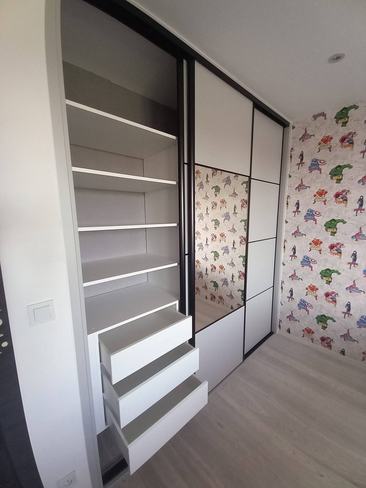 Geöffneter Kasten mit weißen Fachböden und herausgezogenen Laden