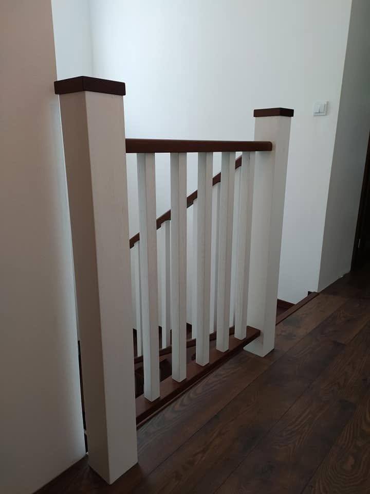 Stiegengeländer über dunklem Holzboden