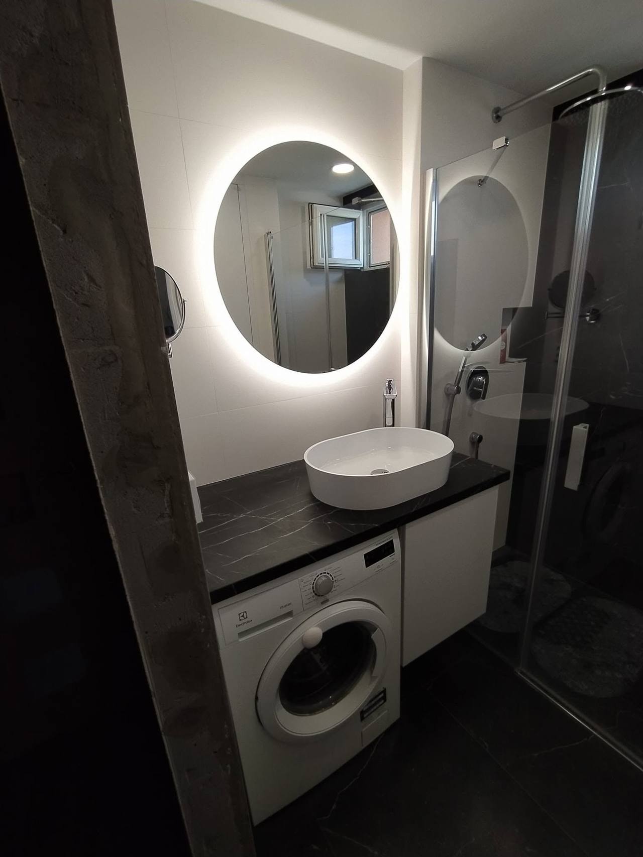 Gesamtblick auf das Bad mit Platte über der Waschmaschine