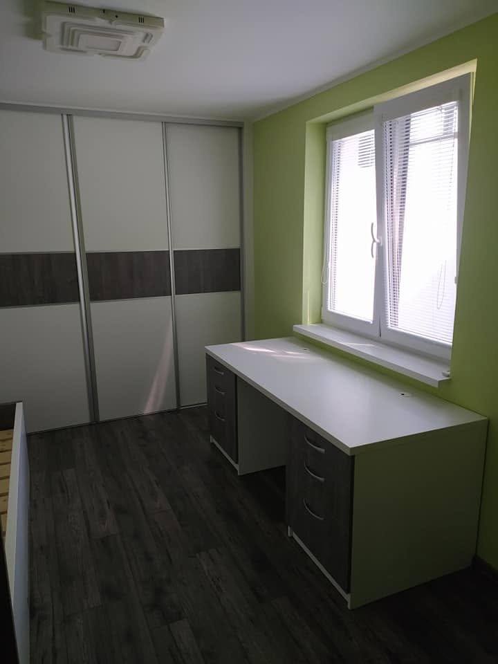 Kinderzimmer mit Fenster, Schwebetürenkasten und Schreibtisch