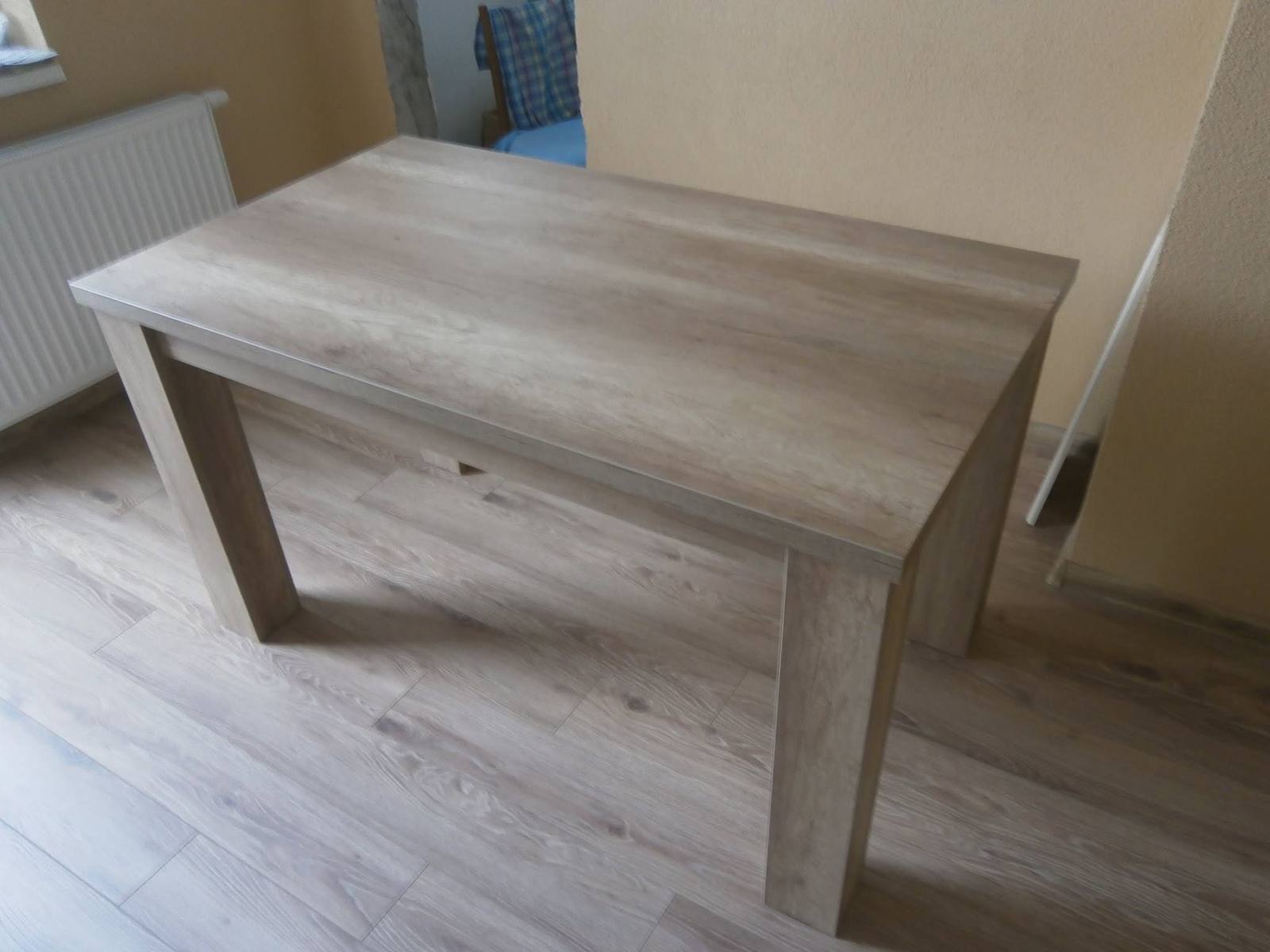 Rechteckiger Tisch mit kantigen Beinen auf Laminatboden