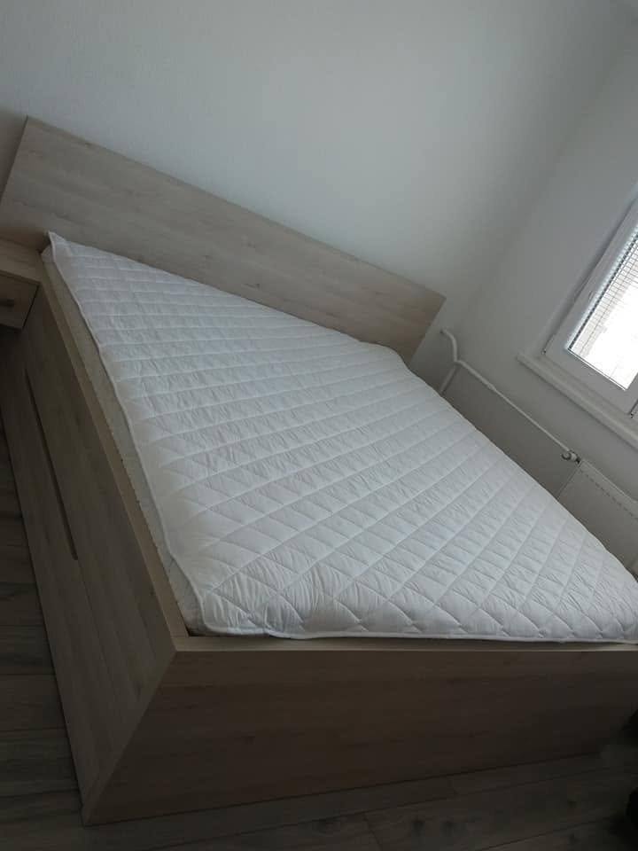 Doppelbett mit neuer Matratze und niedrigem, geradem Kopfteil