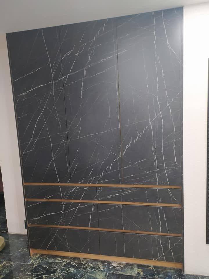 Detail des Hochschranks in schwarzem Marmordekor mit Eichenleisten.