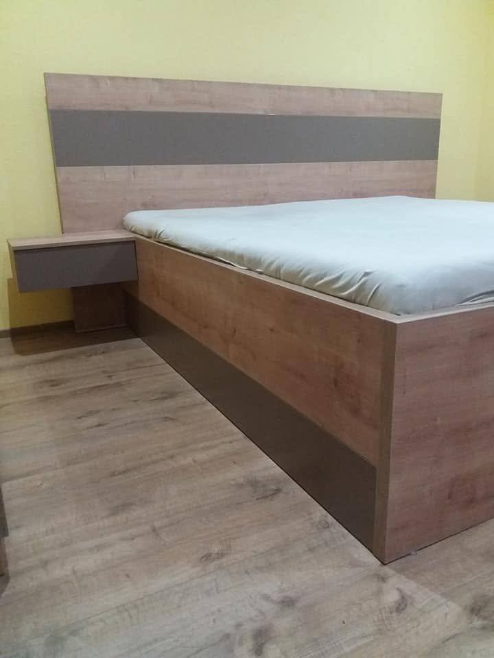 Doppelbett mit anthrazitem Sockel und hängendem Nachtkästchen