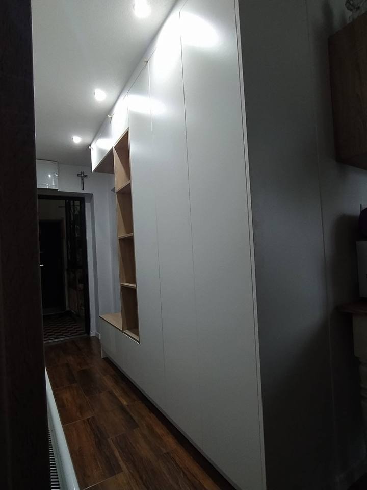Vorzimmer mit weißen grifflosen Schränken und Eichennische