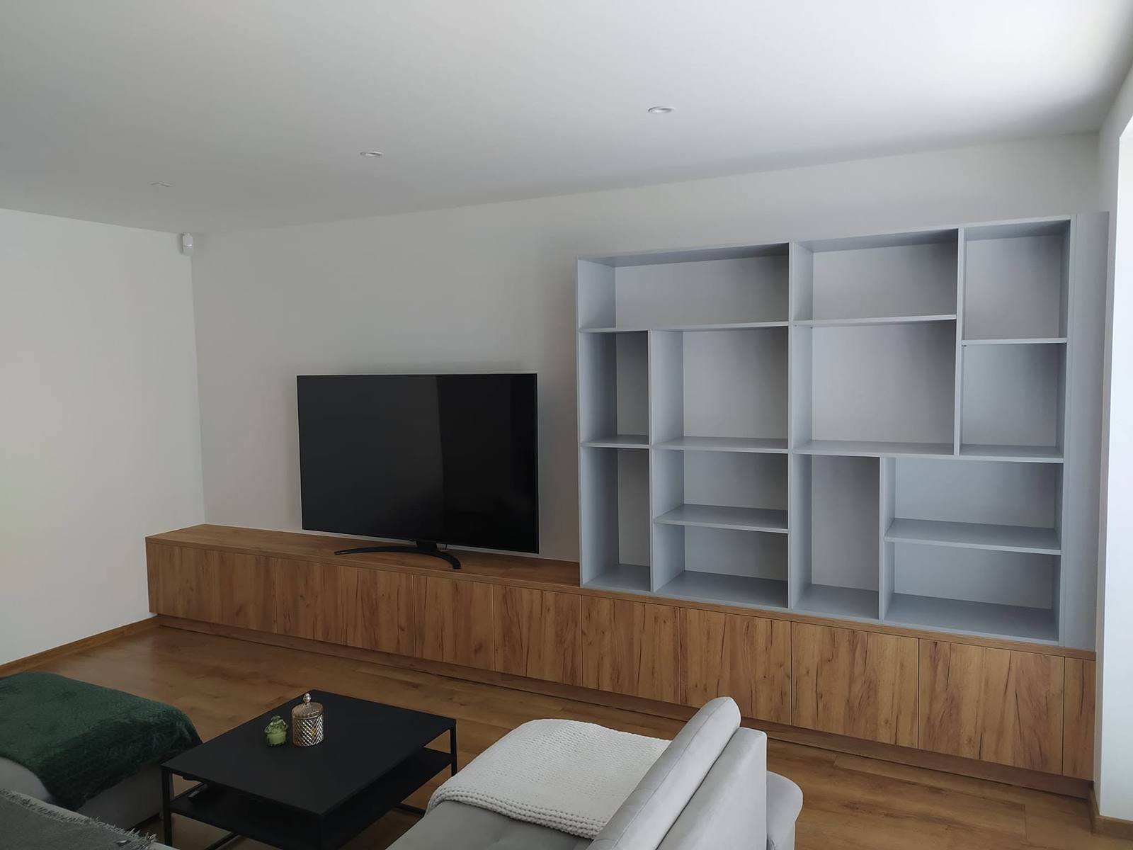 Eichen-TV-Möbel und graues geometrisches Regal im Wohnzimmer