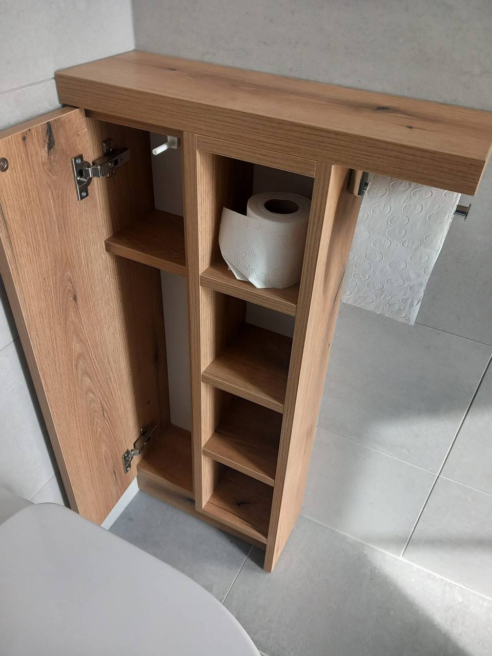 Schmaler Eichenschrank über dem WC mit geöffneter Tür