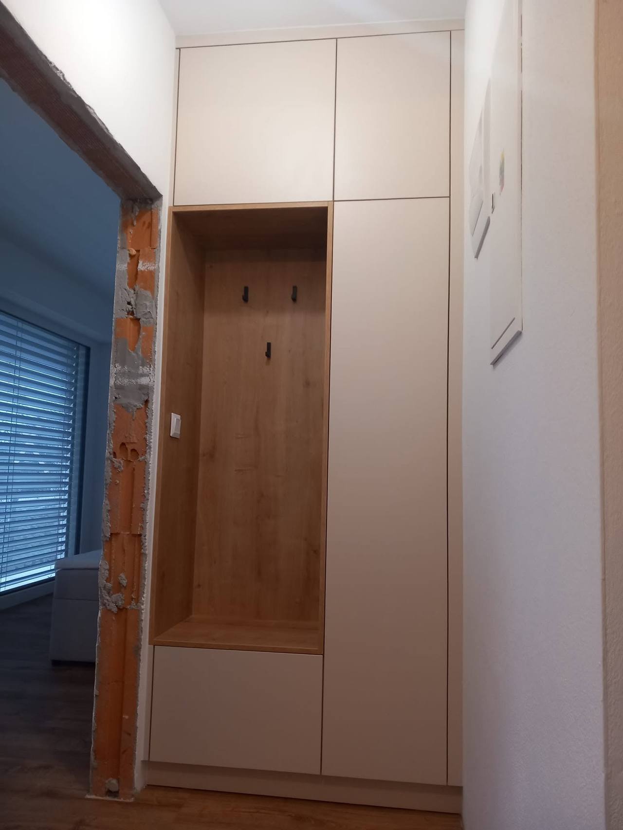 Schmale Eichennische mit Haken und Oberkästen bis zur Decke