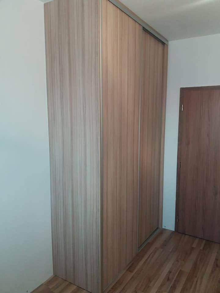 Kasten mit Schiebetüren in Nussbaumdekor im Flur.