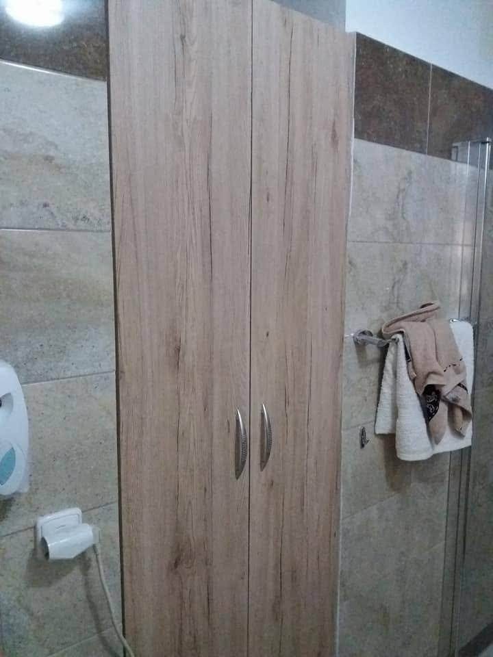 Hoher Badschrank in Grau-Eiche mit geschlossenen Türen