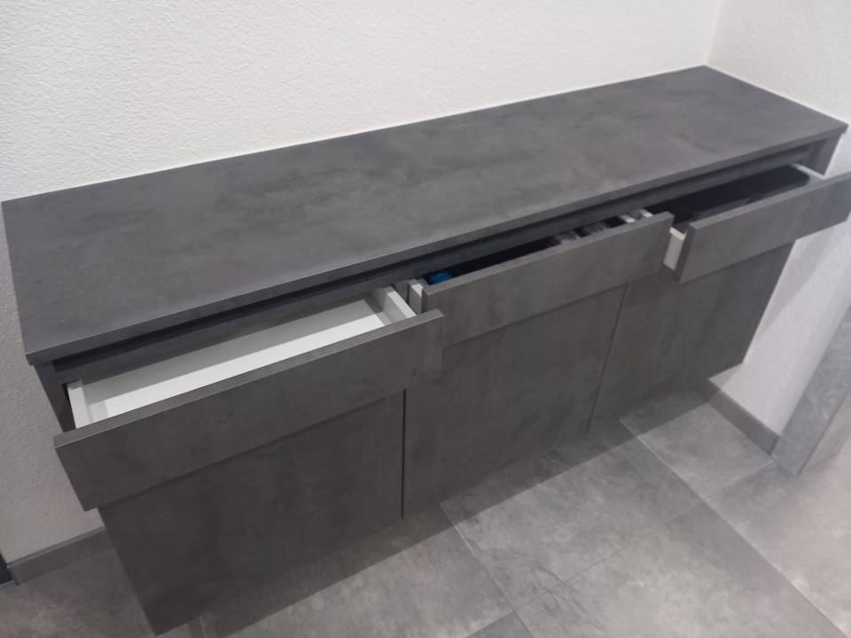 Anthrazitfarbene Kommode mit offenen Laden in Betonoptik