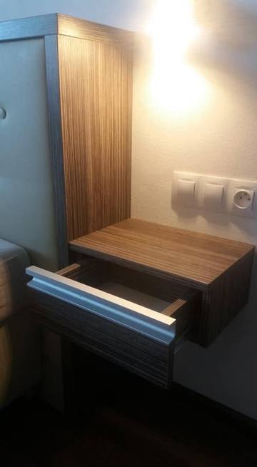 Detail des schwebenden Nachtkästchens mit Licht am Bett